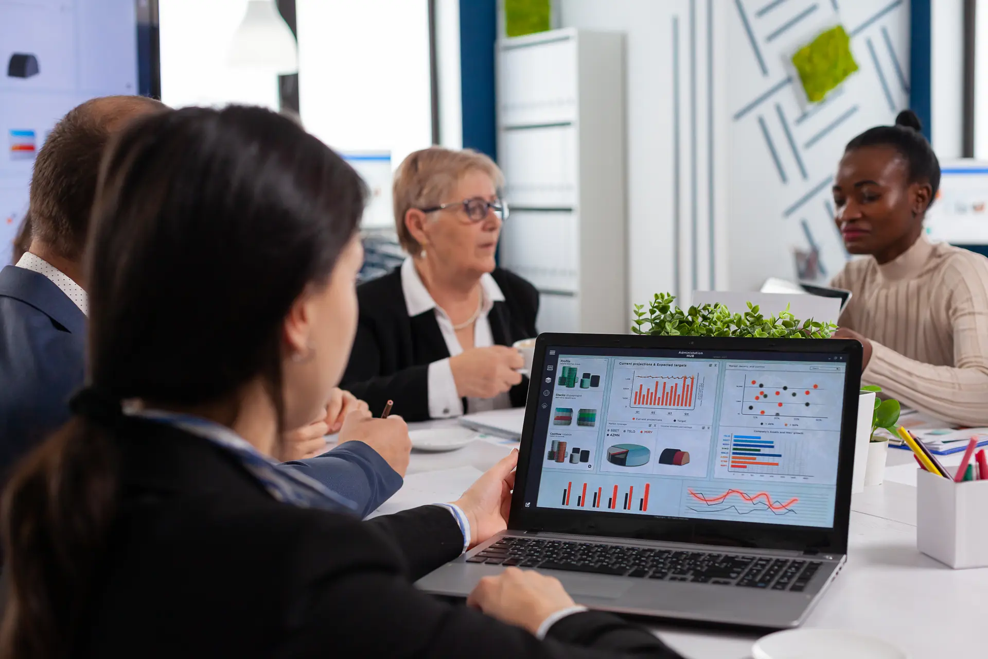 Business leaders and a data analyst reviewing decision-ready insight